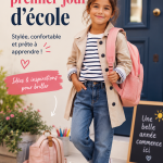Jeune élève portant une tenue tendance pour le premier jour d'école, souriant