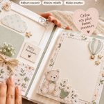 Album photo DIY sur une table avec des outils créatifs et des photos de bébé